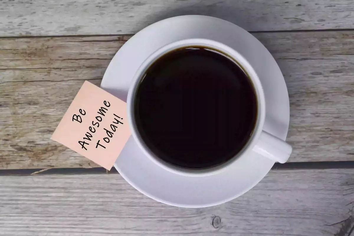 Coffee with a motivational quote for morning routines.